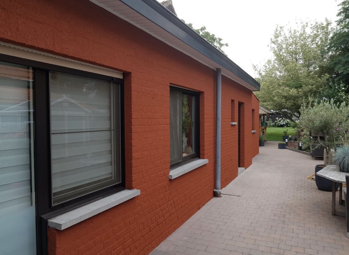 Terracotta spray cork finish on a house facade