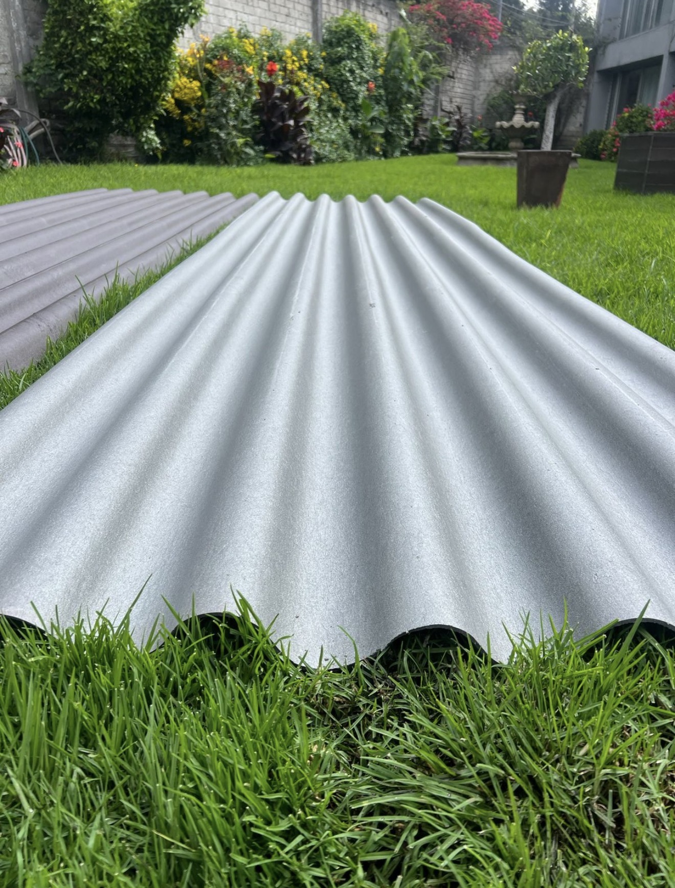 Corrugated PolyAl sheets laid outdoors showing the finished matte surface